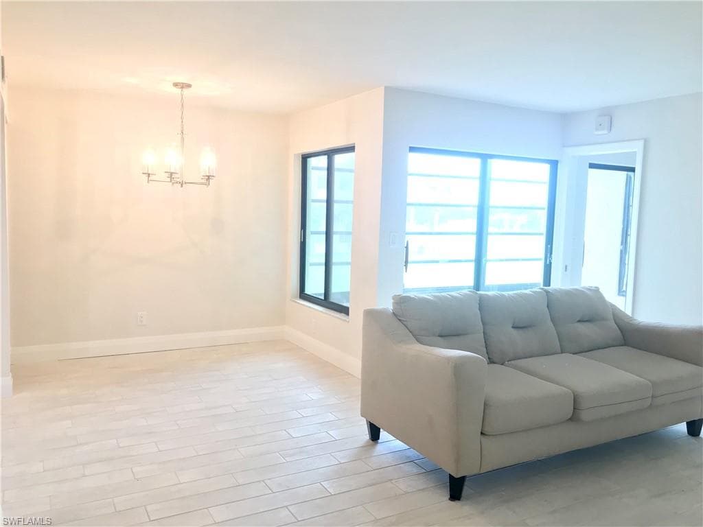 Living/dining room with w/ window and sliders to lanai
