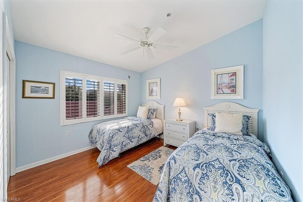 Guest bedroom with plantation shutters and laminate floors