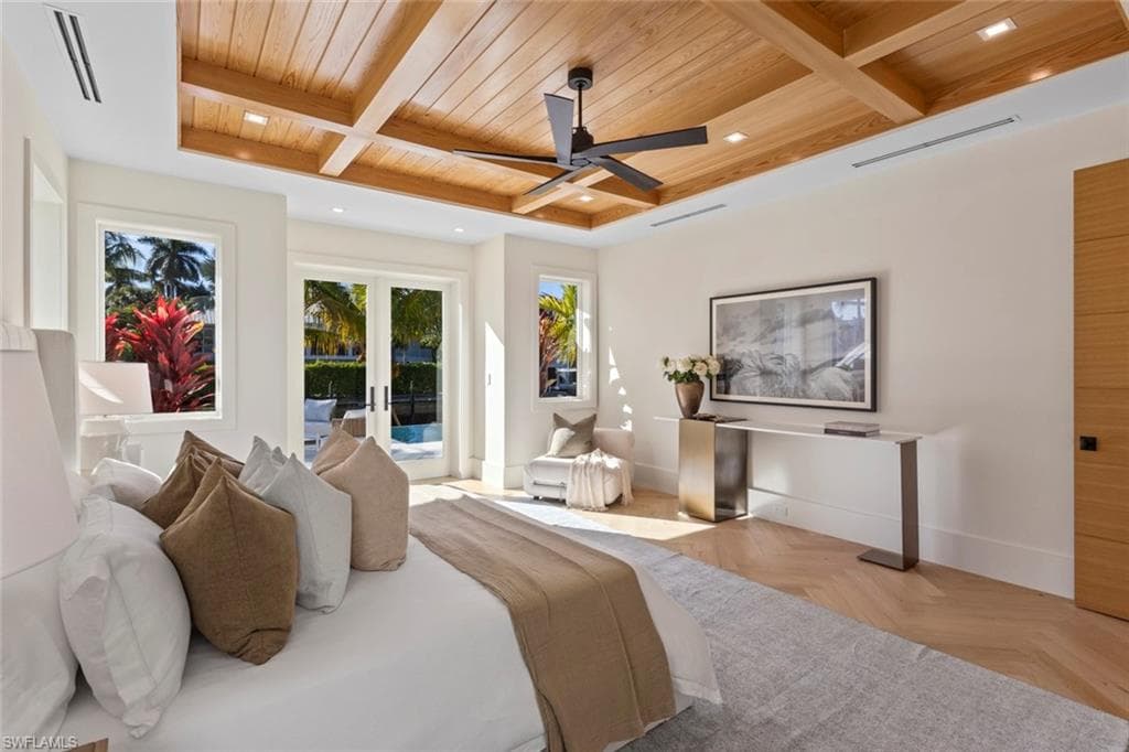 Bedroom with a wooden ceiling with exposed beams, access to outside, coffered ceiling, ceiling fan, and french doors