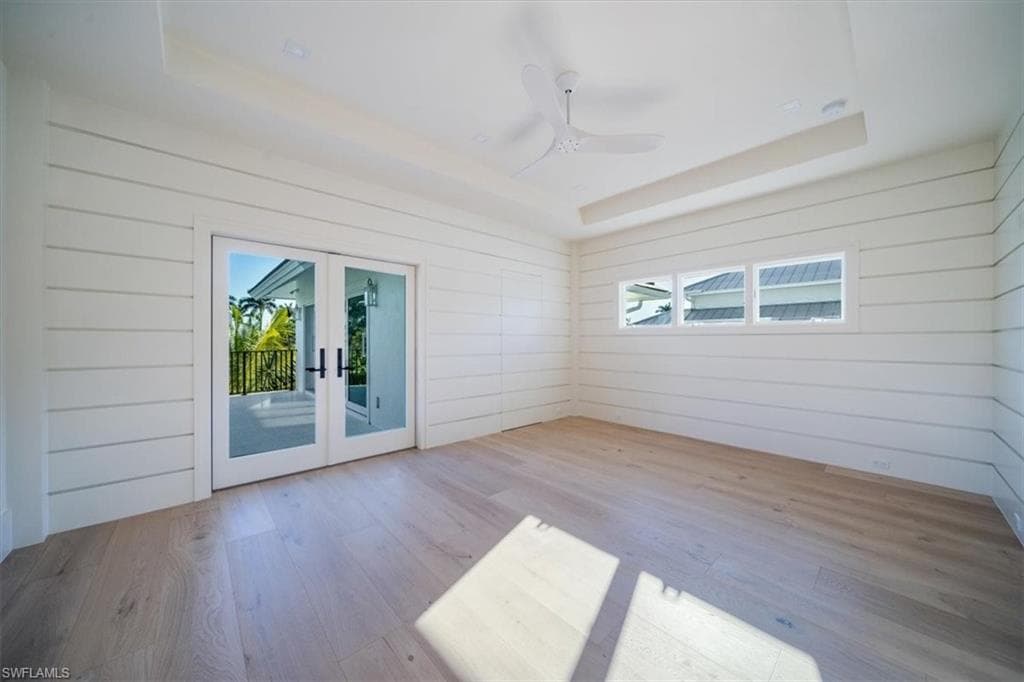 Bedroom #3 with shiplap and balcony access.