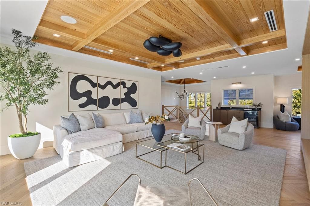 Living area featuring a wood ceiling with exposed beams, parquet floors, and recessed lighting
