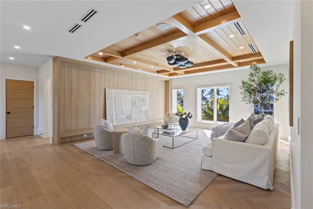 Living area featuring coffered ceiling and a wood ceiling with exposed beams