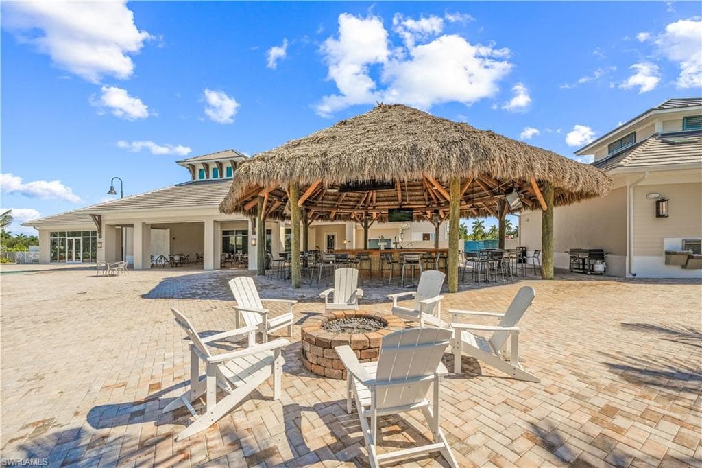 View of patio / terrace featuring an outdoor fire pit and a gazebo