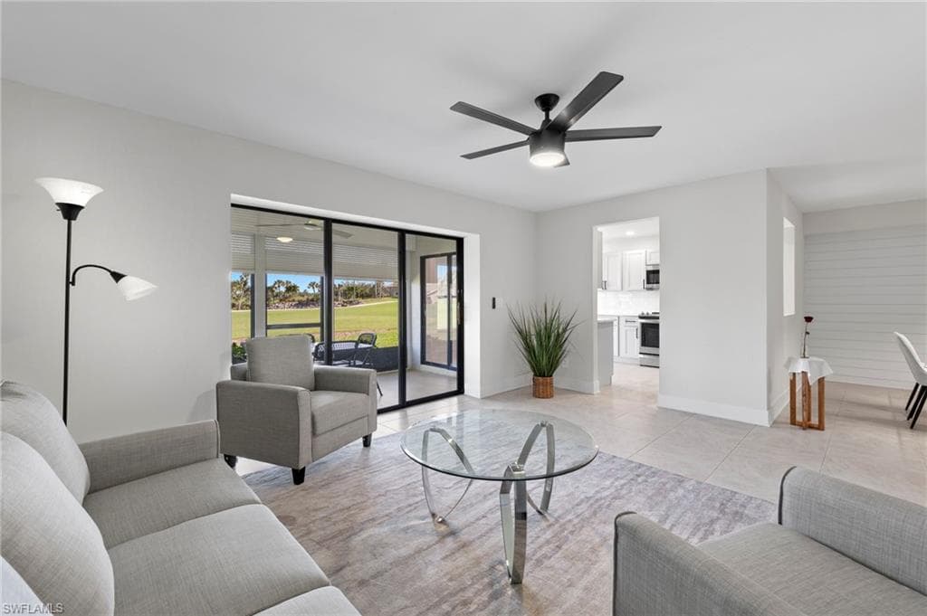 Living room featuring light tile patterned flooring and ceiling fan