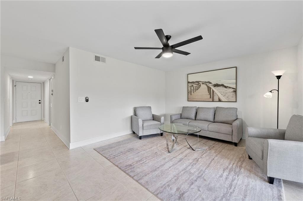 Tiled living room featuring ceiling fan