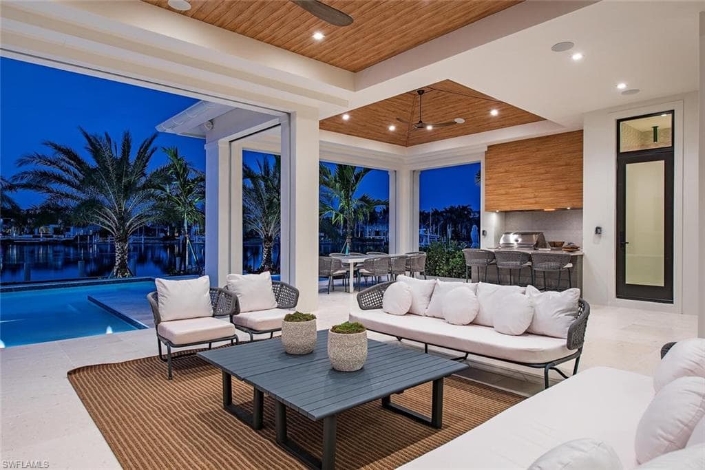 View of patio featuring an outdoor hangout area, an outdoor kitchen, outdoor dining area, and ceiling fan