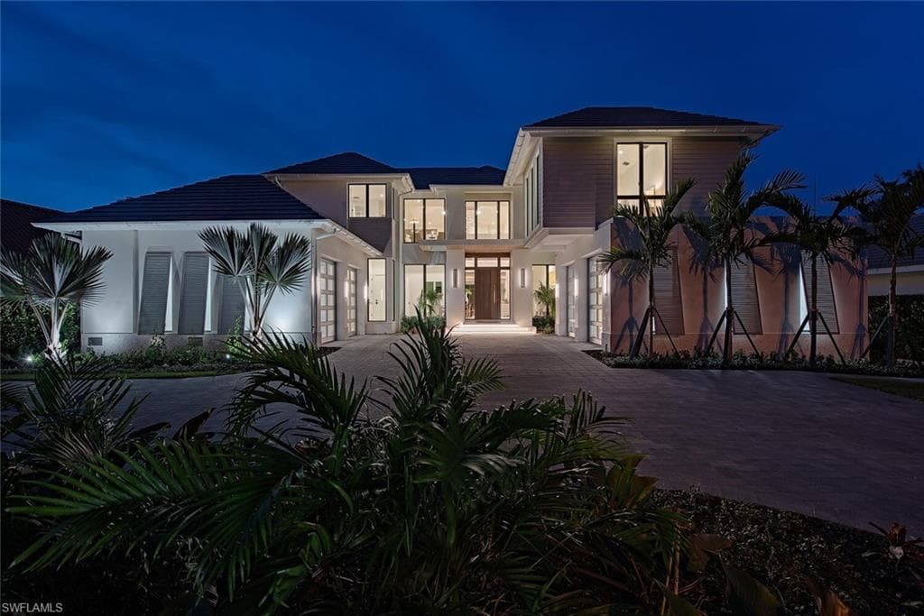 Contemporary home with stucco siding, a balcony, and decorative driveway