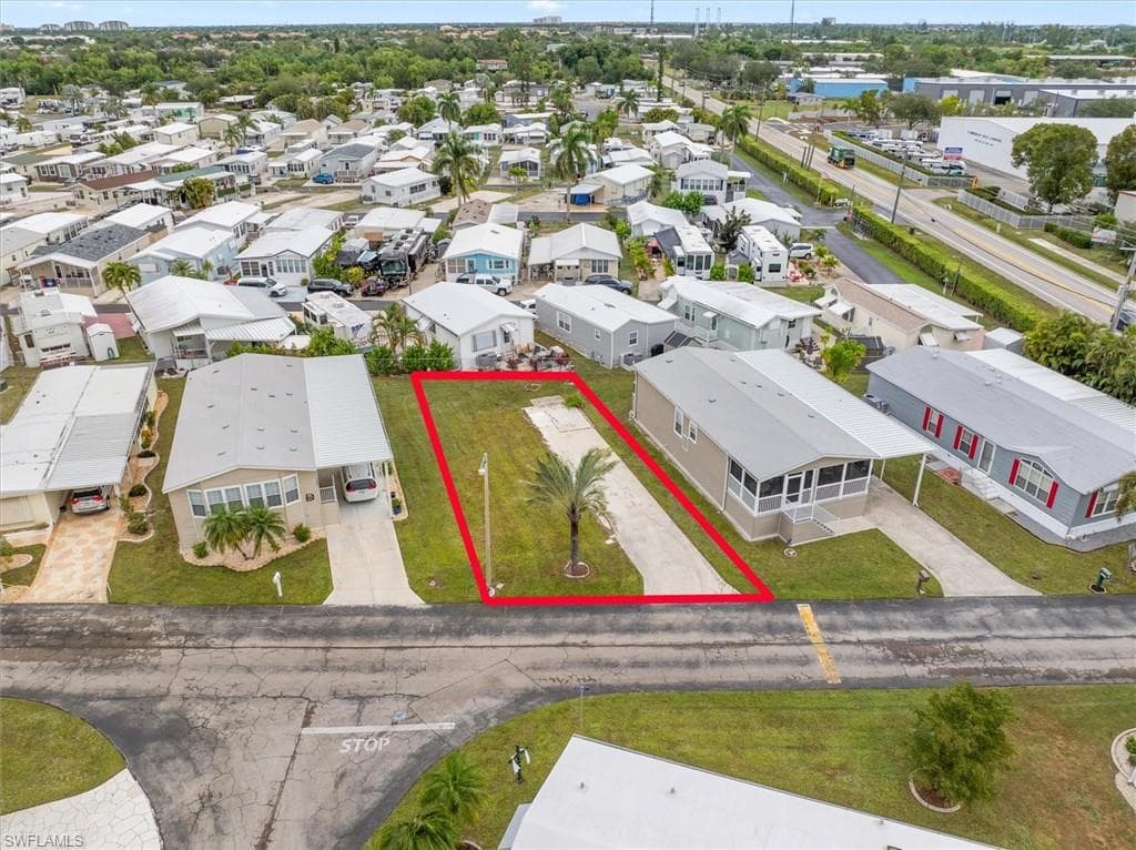Aerial view of residential area featuring property boundaries highlighted