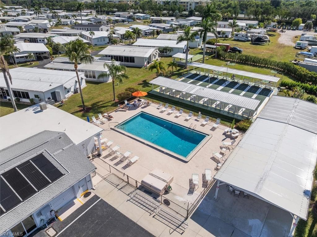 Aerial view of residential area featuring a pool