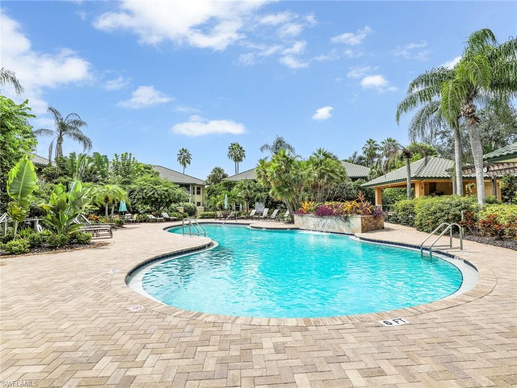 View of Palm Colony swimming pool with a patio