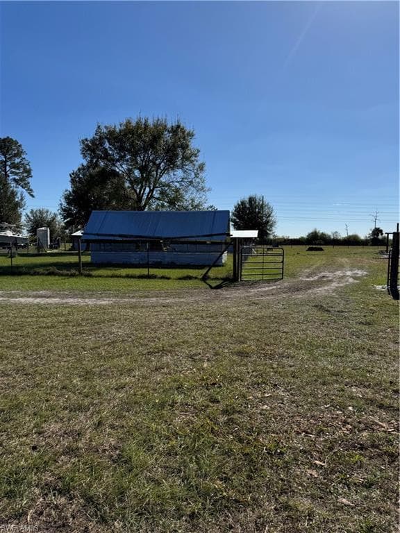 View of yard with a rural view