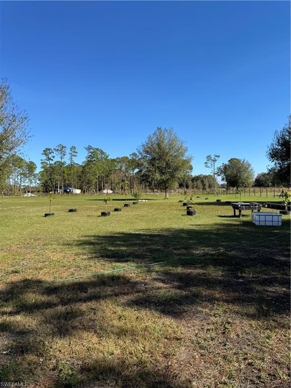 Surrounding community featuring a rural view and a yard