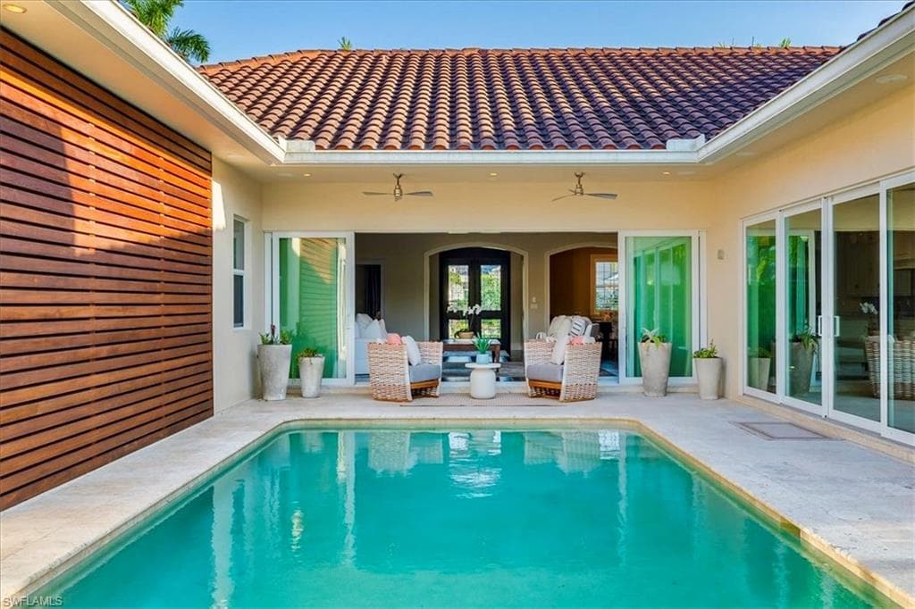 The beautiful Ipe wood wall highlights the large pool area