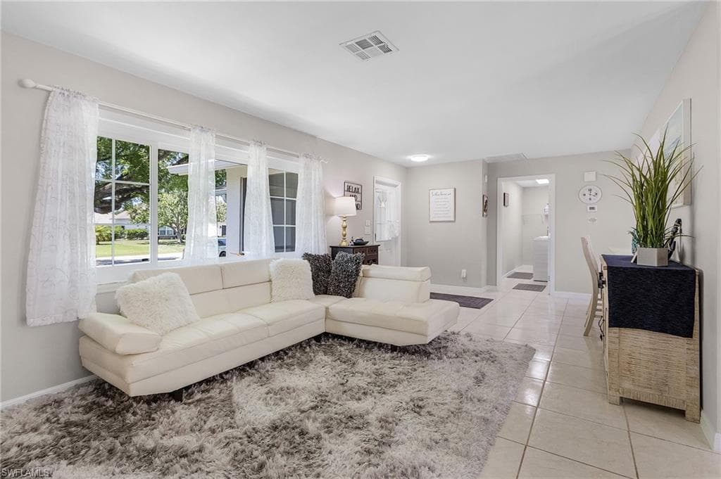 Living room featuring light tile floors