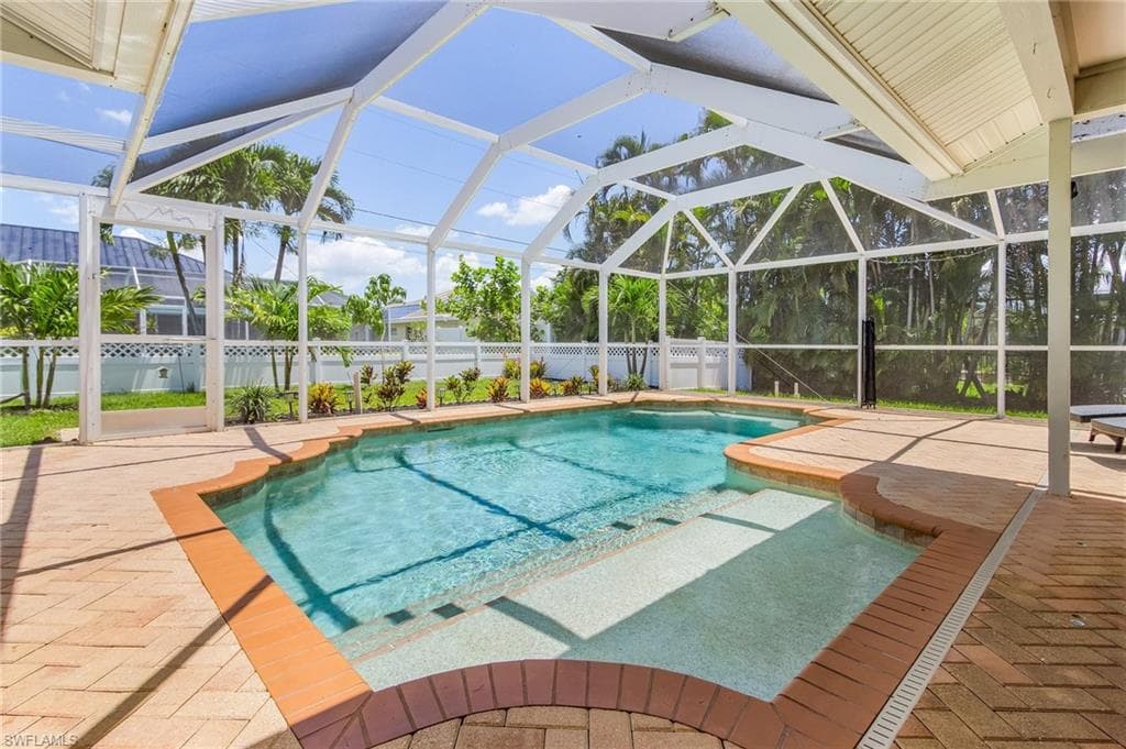 View of pool featuring a patio and a lanai