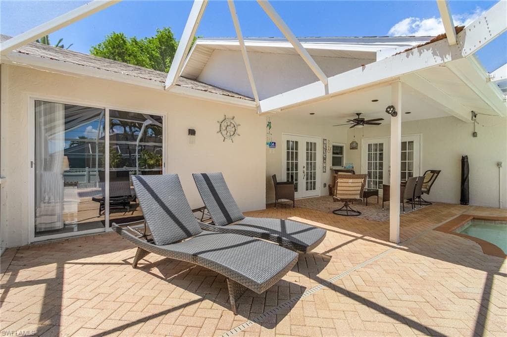 View of patio / terrace featuring french doors, a swimming pool, and ceiling fan