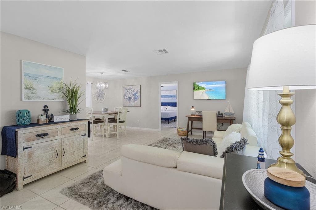 Tiled living room with a chandelier