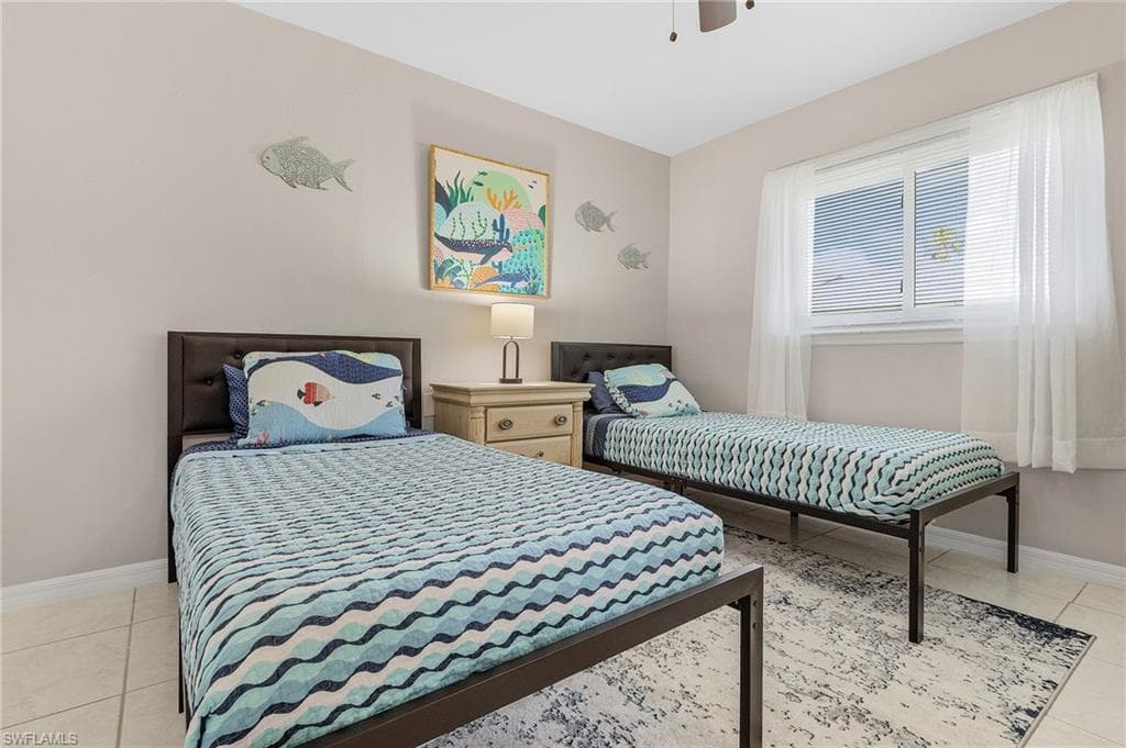 Bedroom featuring ceiling fan and light tile floors