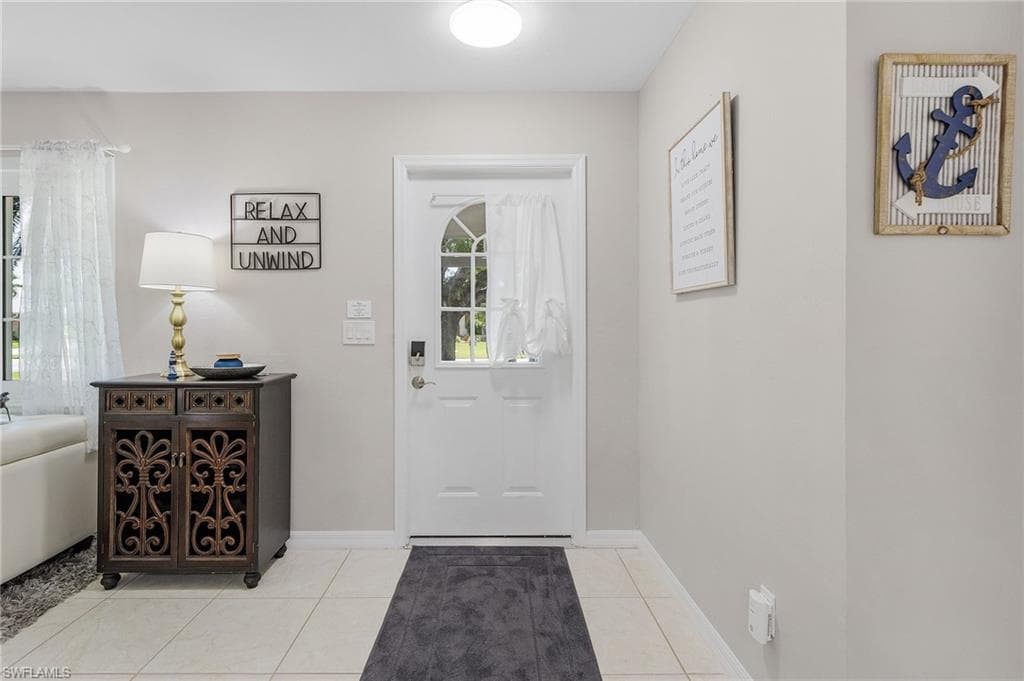 Tiled foyer with a healthy amount of sunlight
