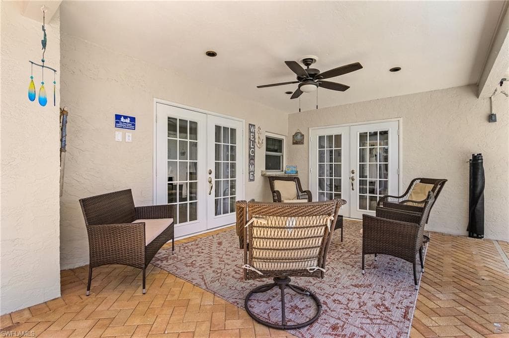 View of terrace with french doors and ceiling fan