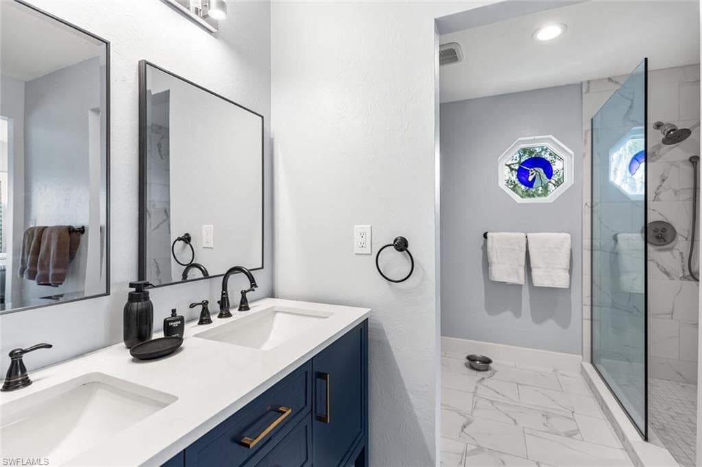 Owner's Suite Bathroom features double vanity with extensive cabinet space, and an enclosed shower