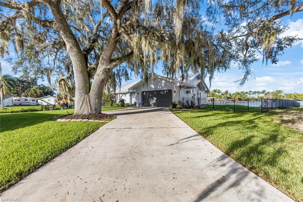 Magnificent live oak tress with Spanish moss. Very dramatic entrance to this home. Spacious 2-car garage. Longer driveway for plenty of guests.