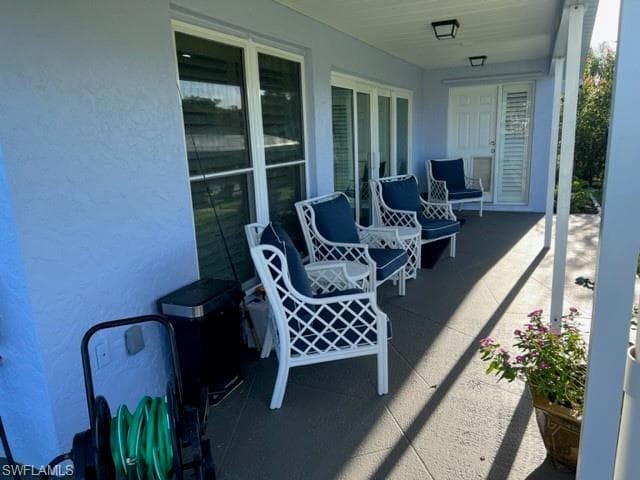 View of patio / terrace. Door in background leads to Owner's Suite. View is towards side yard, canal and dock area.
