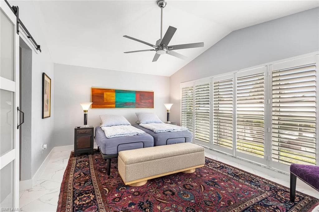 Large Owner's Suite with windows to the canal side of the home. Suite has separate door to patio. Sliding door leads to full bathroom with walk-in closet.