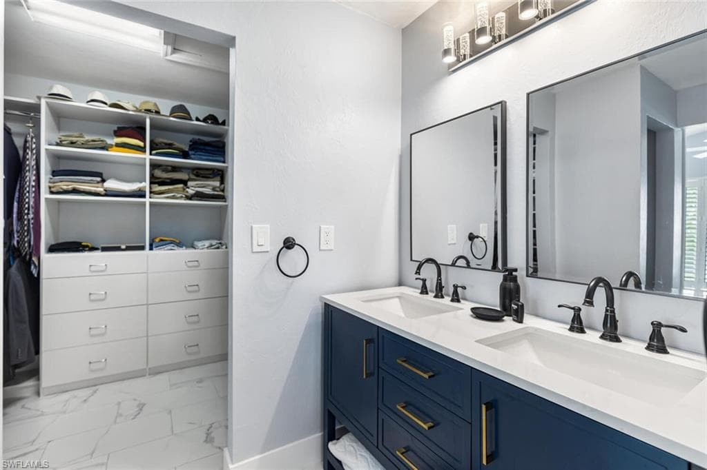 Owner's Suite showing double vanity and walk-in closet with built-ins.