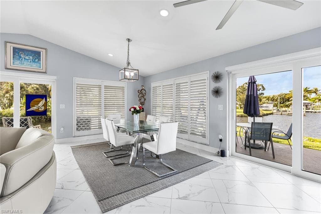 Dining room windows are adjustable wooden plantation shutters. Plenty of room to host larger dinners with spectacular views west. Watch sunset from dining room.