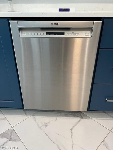 Bosch very quiet dishwasher, blue cabinets, and light porcelain tile floors
