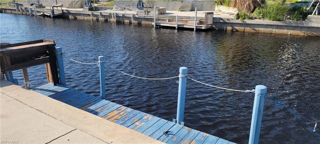 Dock area featuring a water view