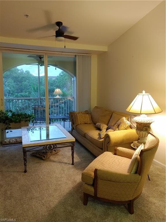 Living room with ceiling fan and carpet floors