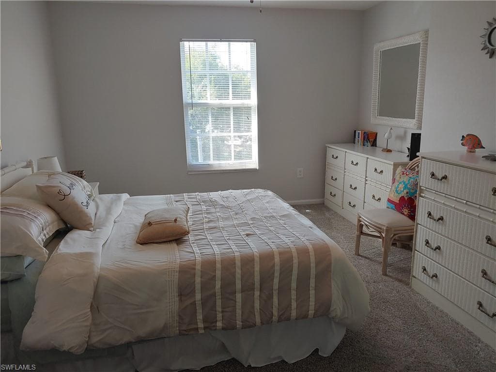 Bedroom featuring light colored carpet