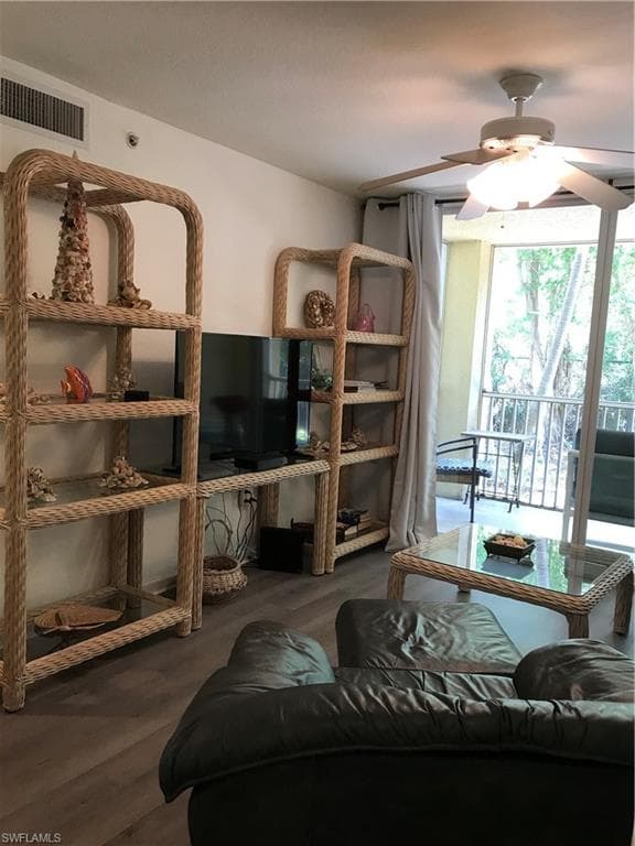 Living room featuring ceiling fan and hardwood / wood-style floors