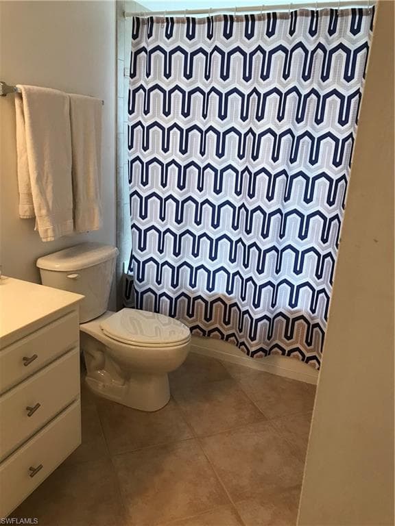 Bathroom with vanity, toilet, and tile floors