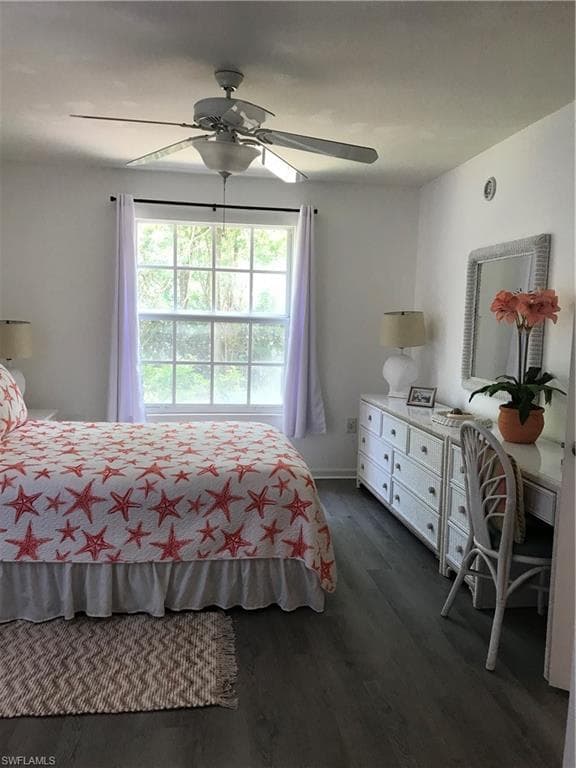 Bedroom featuring ceiling fan and dark hardwood / wood-style floors