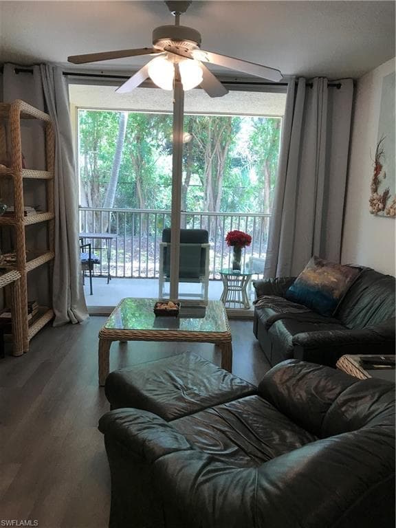 Living room with wood-type flooring and ceiling fan
