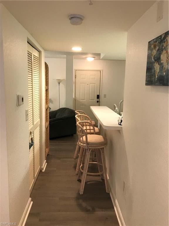 Hallway featuring dark hardwood / wood-style floors