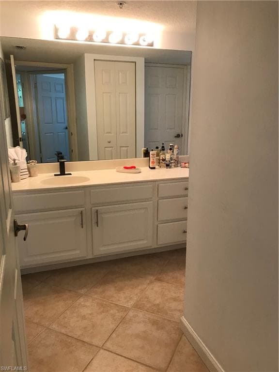 Bathroom featuring tile floors and vanity