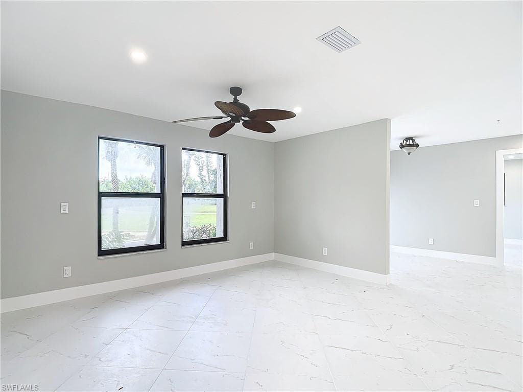 Tiled empty room with ceiling fan