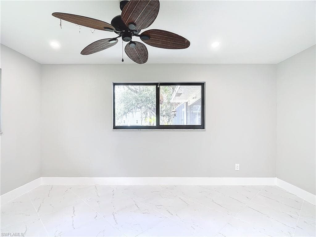 Unfurnished room featuring ceiling fan and light tile flooring