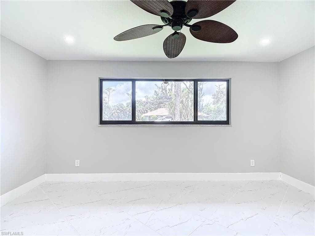 Empty room featuring ceiling fan