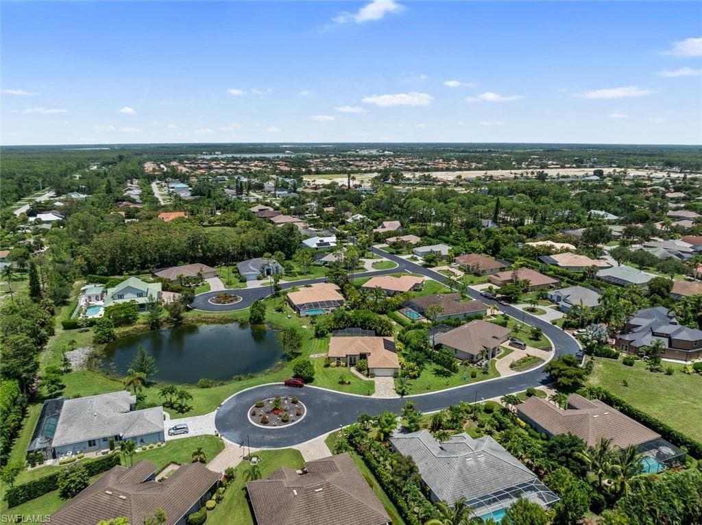 Birds eye view of property with a water view