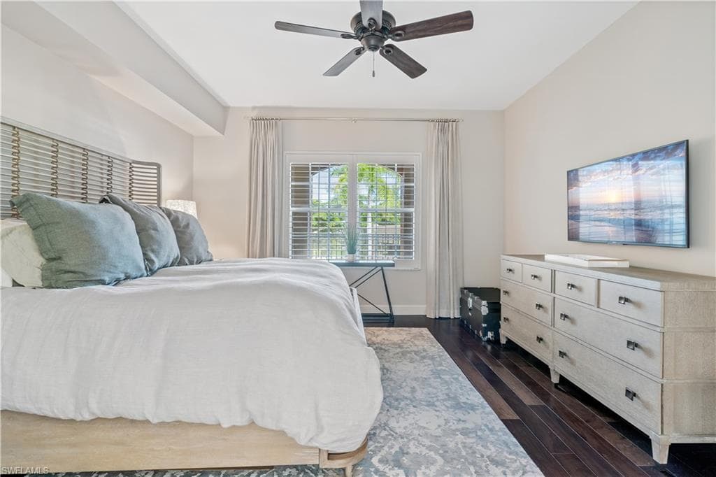 Bedroom featuring ceiling fan and dark hardwood / wood-style floors