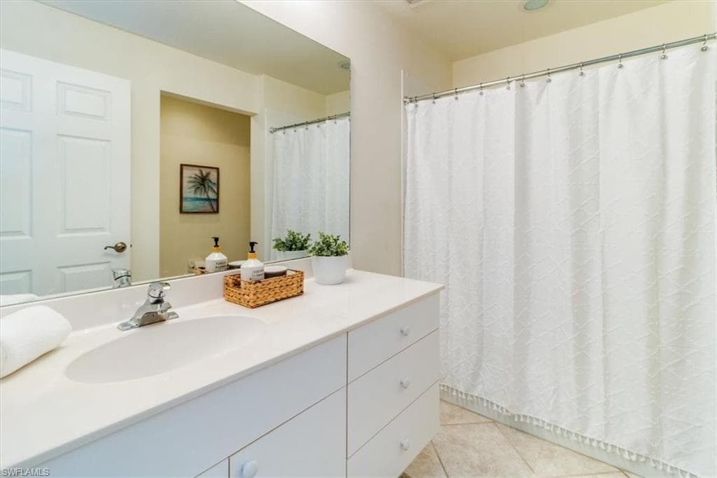 Guest bathroom with a shower over tub