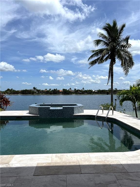 View of swimming pool with an in ground hot tub