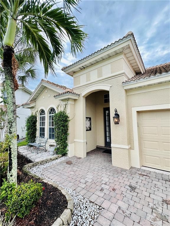 Mediterranean / spanish-style house featuring a garage