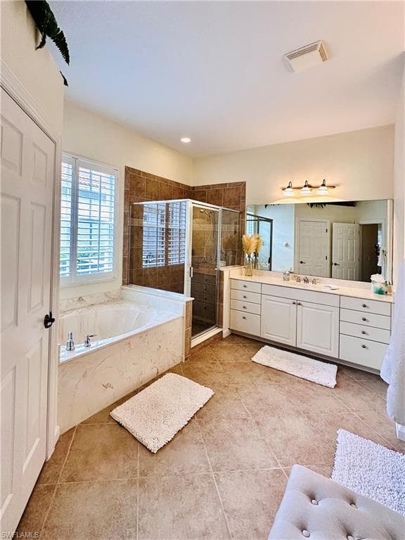 Bathroom with vanity, plus walk in shower, and tile patterned floors