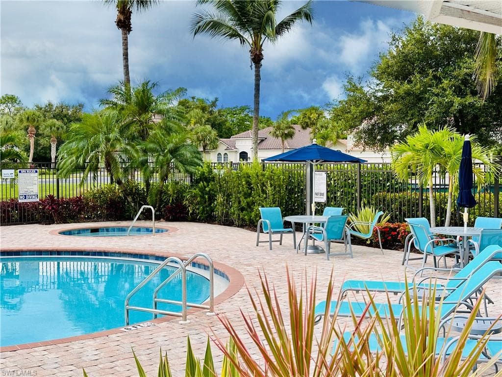 Clubhouse swimming pool with a hot tub and a patio area